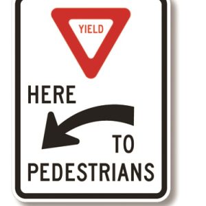 Yield here to pedestrians sign (left arrow)