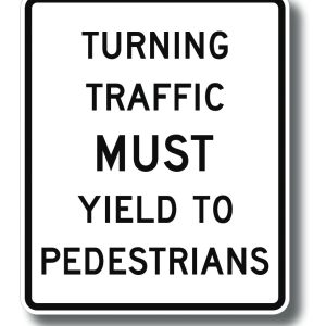 Turning traffic must yield to peds sign