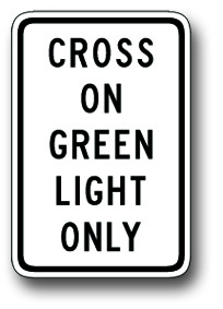 Cross on green light only sign
