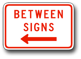 Between signs with arrow sign