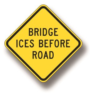 Bridge ices before road sign