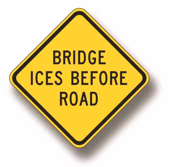 Bridge ices before road sign